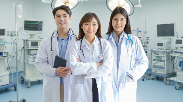 Medicine and healthcare concept : Group of happy and cheerful asian doctors Line up, Male and Female are smiling in Operating Room.