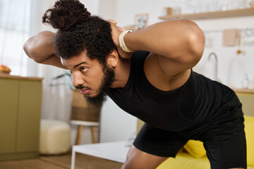 Athletic man shows strength and determination while exercising at home