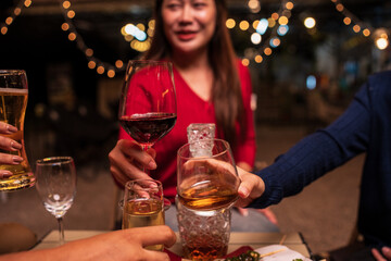 Group of Asians are having a celebration at a restaurant with drinks.