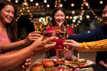 A group of Asian girls celebrate by toasting.
