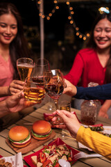 A group of Asian girls celebrate by toasting.
