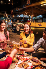 Group of Asians are having a celebration at a restaurant with drinks.	