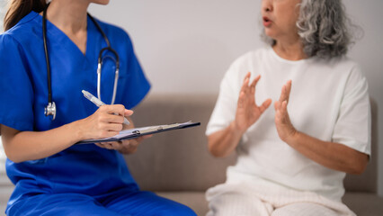 Asian nurse providing nursing care adult patient home consultation medical health service elderly...