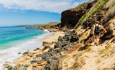 Female Hiker on Volcanic Landscape of Pohakumauliuli Beach, Molokai, Hawaii, USA