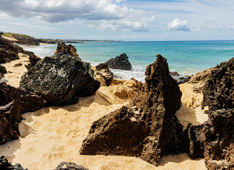 The Volcanic Shoreline Under Black Rock Cinder Cone on Pohakumauliuli Beach, Molokai, Hawaii, USA