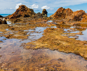 The Volcanic Shoreline Under Black Rock Cinder Cone on Pohakumauliuli Beach, Molokai, Hawaii, USA