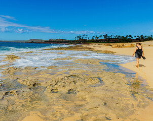Female Tourist Walking on Sand and Coral Reef on Kepuhi Beach, Molokai, Hawaii, USA