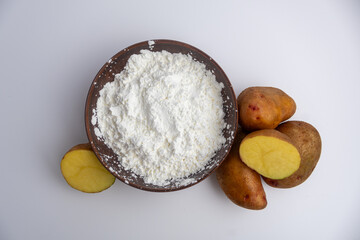 potato starch in a clay bowl on a white background