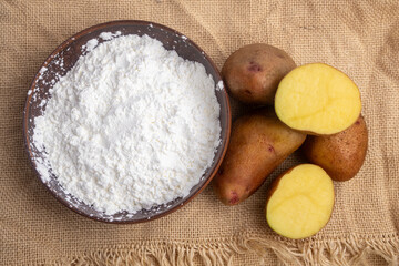 potato starch in a clay bowl on a linen tablecloth
