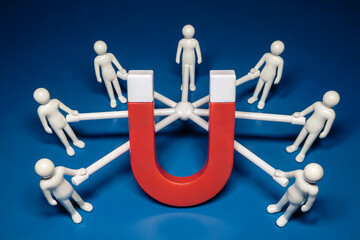 A Product Photography Shot of a Red U-Shaped Magnet Attracting White Figures Connected by White Bars on a Blue Background
