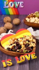 Heart-shaped mix of nuts and dried fruit, rainbow pride colors