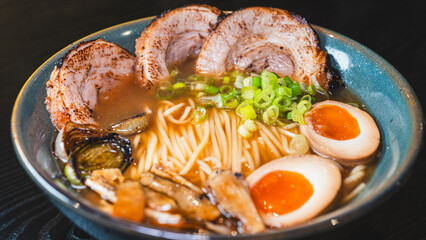 Delicious pork chashu ramen with tender marinated pork, tamago egg, and bamboo shoots in a beautiful bowl. Rich broth, perfect for Japanese cuisine lovers.