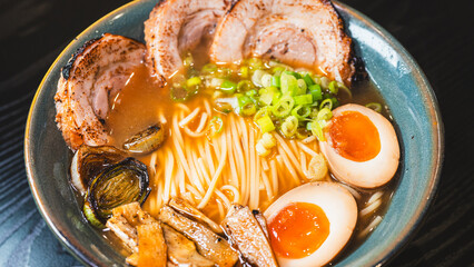 Delicious pork chashu ramen with tender marinated pork, tamago egg, and bamboo shoots in a beautiful bowl. Rich broth, perfect for Japanese cuisine lovers.