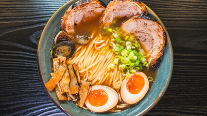 Delicious pork chashu ramen with tender marinated pork, tamago egg, and bamboo shoots in a beautiful bowl. Rich broth, perfect for Japanese cuisine lovers.