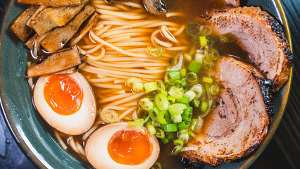 Delicious pork chashu ramen with tender marinated pork, tamago egg, and bamboo shoots in a beautiful bowl. Rich broth, perfect for Japanese cuisine lovers.