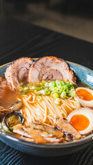 Delicious pork chashu ramen with tender marinated pork, tamago egg, and bamboo shoots in a beautiful bowl. Rich broth, perfect for Japanese cuisine lovers.