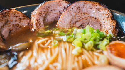 Delicious pork chashu ramen with tender marinated pork, tamago egg, and bamboo shoots in a beautiful bowl. Rich broth, perfect for Japanese cuisine lovers.