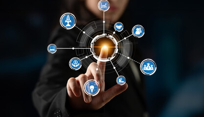 A business professional engages with a digital interface filled with icons representing various themes of innovation, connectivity, and data analysis in a modern workspace. Crux