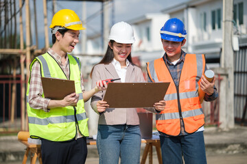 Architect and contractors collaborate at a jobsite, discussing blueprints.