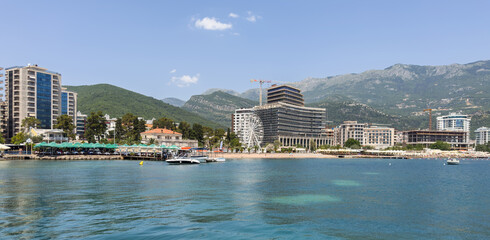 Budva, Montenegro: A vibrant mix of beachfront activity, modern development, and a towering Ferris...