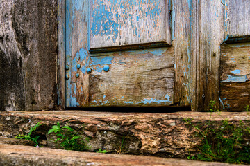 Details of an old baroque church door made of wood, weathered by time, in Ouro Preto city