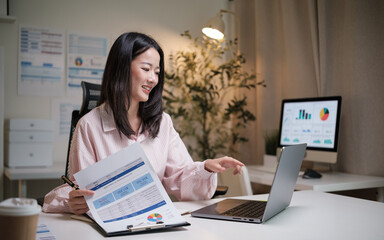 Smiling businesswoman presenting financial data during a virtual meeting.