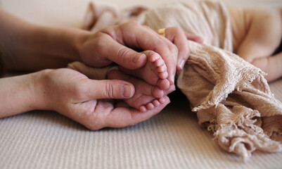 Mom Is Stroking Newborn Baby'S Legs