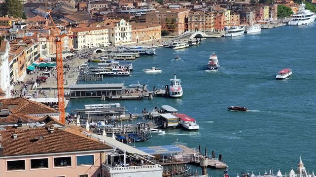 Venice lagoon waterfront with boats, historic buildings along the shore. High angle view 