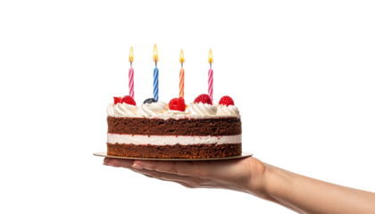 A hand holding a delicious birthday cake with lit candles, perfect for a celebration. The cake has white frosting and red fruit
