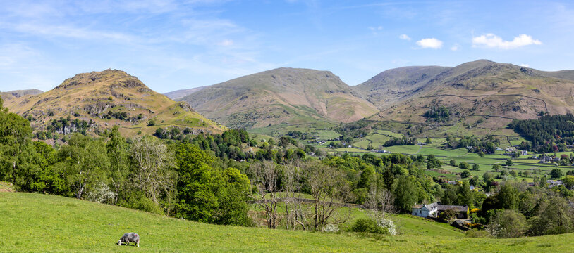 panoramic view of grasmere village from silver howe with helm crag on the left and seat sandal fairfield and stone arthur centre to right sunny spring day no people