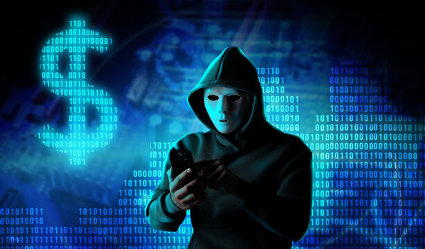 Cyber attack. Hacker in mask using mobile phone. Blue binary code and dollar sign