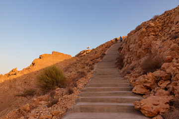 A hiking trail on khoneh Mountain in Oman during golden hour, showing rocky terrain, steep steps, and beautiful desert landscape. Sultanate of oman , November 01 2025.  