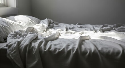 Unmade Bed with Crumpled Sheets in Soft Light