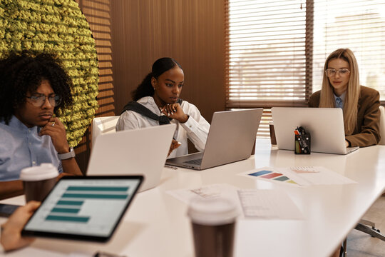 Business team focused on data analysis during corporate meeting
