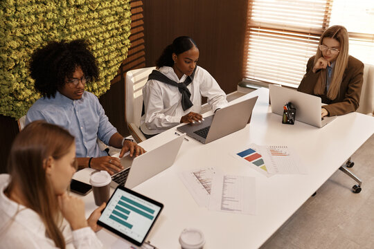 Business team focused on data analysis during corporate meeting