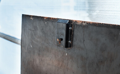 Open trapdoor locking part. Close up of open staircase hatch in scaffolding tower. Construction site safety and security. Prevent work related accident concept. Selective focus.