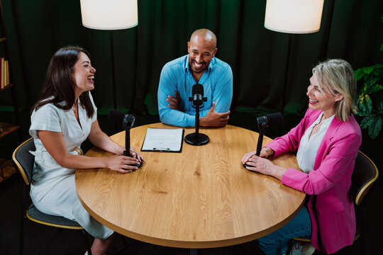 Group of three diverse hosts having a podcast discussion