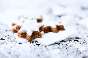 Christmas cookies (cinnamon stars) on bright background. Close up.	