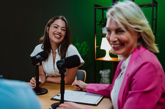 Diverse people broadcasting live podcast interview using microphones