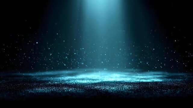 Blue spotlight beams through fog onto a dark stage, illuminating shimmering particles in the air.