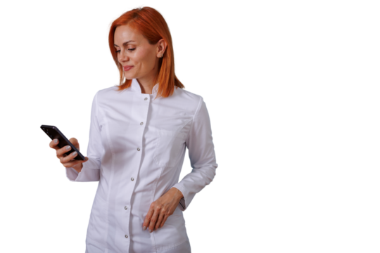 Woman doctor in white coat texting on smartphone, smiling while connecting with patients or colleagues, transparent background