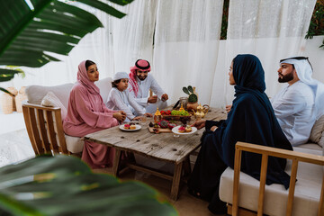 Emirati family at home. Muslim family sharing iftar at countryside home.