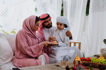 Arab family celebrating eid with sweet dessert