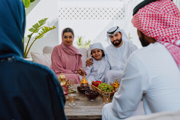 Emirati family at home. Muslim family sharing iftar at countryside home.
