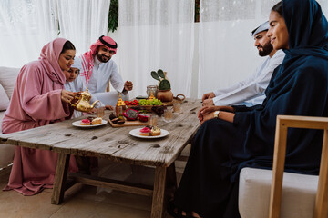 Emirati family at home. Muslim family sharing iftar at countryside home.