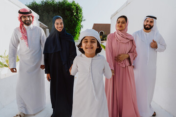 Emirati family standing together and smiling outdoors