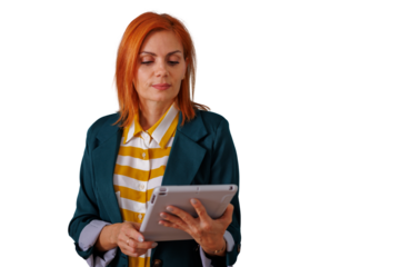 Redhead businesswoman holding a tablet, engaging with digital content for work, symbolizing connectivity and modern business