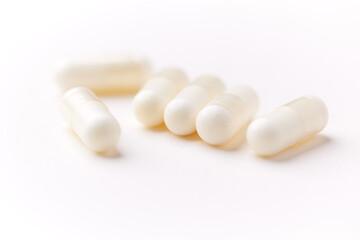 Creatine tablets on paper background. Soft focus. Close up. Copy space.	