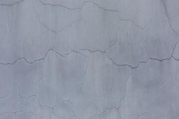 An old, peeling concrete wall with cracks. Construction and renovation. Background. Space for text.