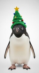 Fototapeta premium penguin wearing a Christmas tree hat, holiday animal graphic, on a white background